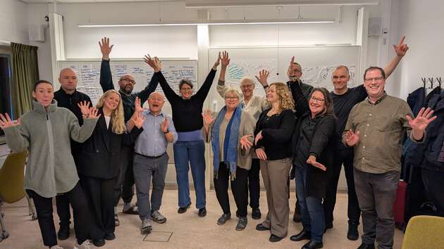 Group picture from the Workshop showing 12 people laughing.