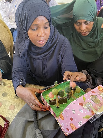 Two students are studying a tiny box
